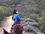 The birthday girl flashes a smile while riding her trusty steed, July.