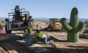 A team effort: Jake Lambert lowers the cactus balance beam while Jerry Thomas pushes it into place.