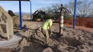 A.J. Kimminau rakes and smooths some of the 200-plus yards of wood shavings while Jake Lambert gets another load.