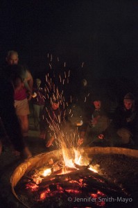At the end of the full moon hike, hikers toast marshmallows over a campfire